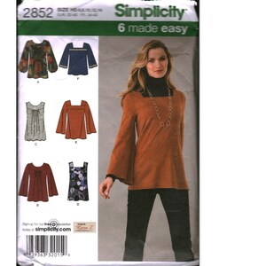 May include: A Simplicity 2852 sewing pattern envelope featuring six variations of a tunic top with long bell sleeves or sleeveless designs. The cover displays a model wearing a rust-colored long-sleeved tunic over a black turtleneck and pants.