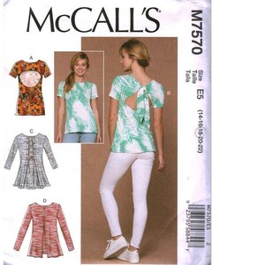 May include: McCall's M7570 sewing pattern envelope featuring four top variations. View A shows a floral print top with a back cutout. View B displays a green and white palm leaf print top with a back tie. View C has a lace-up back, and View D is a long-sleeve top.