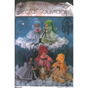 May include: Simplicity crafts pattern featuring five handmade angel dolls with colorful yarn hair and gingham dresses. The dolls are posed on a cloud background with stars. The pattern is labeled "Crafts/Ouvrages".