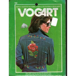 May include: A green Vogart repeat transfer patterns envelope, number 760, featuring a person wearing a blue denim jacket with a large red rose embroidery on the back, small red floral accents, and white text labels in English and French.
