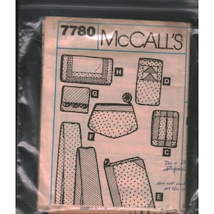 May include: A vintage McCall's sewing pattern packet, featuring various illustrated designs of pouches and accessories. The packet is sealed in a clear plastic bag. The pattern number 7780 is visible at the top.