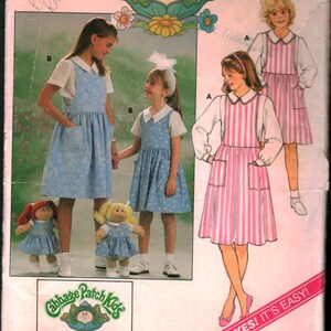 May include: Vintage Butterick sewing pattern featuring Cabbage Patch Kids designs. The pattern includes instructions for making dresses and aprons for children. The cover showcases illustrations of the finished garments, with the Cabbage Patch Kids logo prominently displayed.