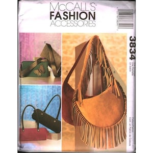 May include: McCall's Fashion Accessories sewing pattern envelope 3834 featuring illustrations of various handbags. Designs include a large tan hobo bag with long fringe, a green clutch with a butterfly applique, and several structured shoulder bags.