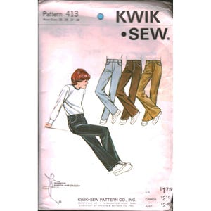 May include: A Kwik Sew pattern envelope, number 413, featuring illustrations of pants in light blue, dark brown, and tan. The cover displays a person wearing dark pants and a white long-sleeve shirt, with text indicating waist sizes 26-28 inches.