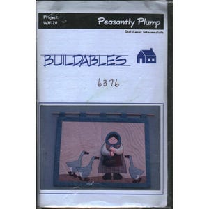 May include: A sewing pattern titled "Buildables" with the text "Peasantly Plump." The pattern features a quilted design of a woman with geese. The skill level is intermediate. The project number is WH120 and the pattern number is 6376.
