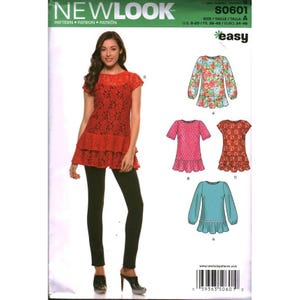 May include: New Look sewing pattern S0601 for a tiered tunic top. The envelope displays a model wearing a red lace tunic with black leggings, alongside illustrations of four variations featuring different sleeve lengths, floral prints, and solid colors.