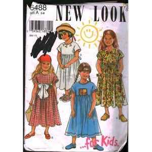 May include: A vintage sewing pattern for children's dresses, featuring illustrations of girls in various dress styles. The pattern cover includes the text "NEW LOOK" and "...for Kids". The dresses are in red, white, blue, and floral patterns.