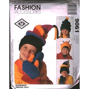 May include: A McCalls Fashion Accessories sewing pattern envelope 9061 featuring illustrations of three different hat designs. The hats include a multi-colored striped pointed cap, a solid orange cap with antennae, and a dark blue and yellow cap.