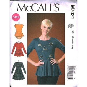 May include: McCall's M7021 sewing pattern featuring a woman's top with peplum and embellishments. The pattern includes multiple style options, with sizes B5 (8-10-12-14-16). The cover displays a teal top with decorative accents.