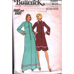 May include: Butterick sewing pattern 3991, size 10, featuring illustrations of two dresses. One is a floor-length teal dress with long sleeves and trim, the other is a knee-length maroon dress with a collar, long sleeves, and pink hem accents.