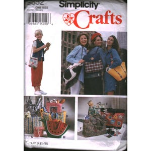 May include: A Simplicity Crafts sewing pattern envelope featuring various handmade bag designs. The cover displays illustrations of shoulder bags, totes, and purses in diverse patterns including cow print, plaid, stripes, and a watermelon slice shape.
