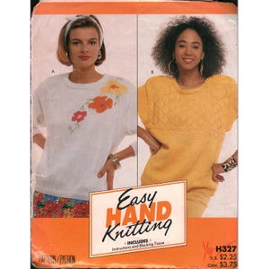 May include: A sewing pattern envelope titled Easy Hand Knitting featuring two sweater designs. One is a white long-sleeve sweater with floral embroidery, and the other is a yellow short-sleeve sweater with a textured knit pattern on the upper chest.
