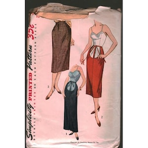 May include: A vintage Simplicity printed pattern envelope featuring illustrations of three skirt and top ensembles. The designs include a brown plaid skirt, a red skirt with a white top, and a dark blue skirt with a light blue top, all with 35c printed.