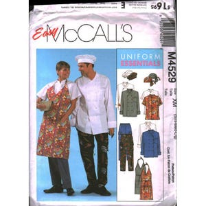 May include: A McCalls sewing pattern envelope for uniform essentials, model M4529. The front shows a person in a floral apron and another in a white chef coat and dark patterned pants, with illustrations of various tops, pants, and aprons included.