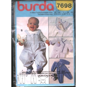 May include: Burda 7698 sewing pattern envelope featuring baby clothing designs. The front displays a child in blue and white striped overalls, alongside images of a bib, a patterned wrap-style top, and a solid blue jumpsuit with matching booties.