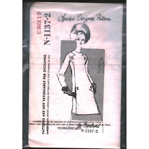 May include: A Spadea Designer Pattern N-1137-2 sewing pattern envelope in a clear plastic bag. The front features a black and white illustration of a long-sleeved coat, text reading C SIZE 10, and a safety warning about suffocation.