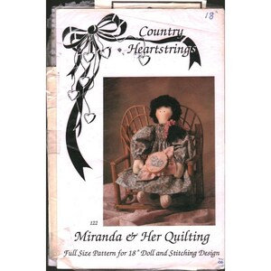May include: A sewing pattern titled Country Heartstrings Miranda & Her Quilting for an 18 inch doll. The cover features a black and white ribbon graphic with hearts and a photograph of a fabric doll with black hair in a floral dress sitting in a chair.