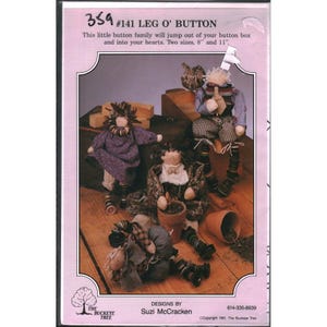 May include: A pink-toned image featuring handmade button dolls. The dolls have button legs and are dressed in various fabrics. The text reads "#141 LEG O' BUTTON" and mentions two sizes: 8 and 11 inches. The Buckeye Tree logo is visible.