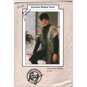 May include: A sewing pattern titled "Summer Breeze Tunic" featuring a woman wearing the tunic. The tunic is a patchwork design in shades of green, blue, and tan. The pattern includes the Merchant Rag logo and the text "interesting clothing to sew."