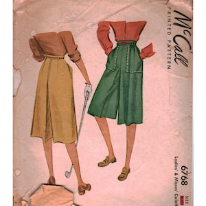May include: A vintage McCall's printed pattern envelope 6768 for ladies' and misses' culottes. The illustration features two figures wearing long-sleeved shirts paired with a tan skirt and green culottes, with one figure holding a golf club.