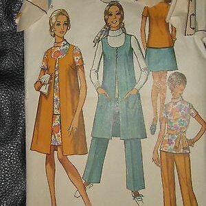 May include: A vintage sewing pattern featuring three different dress designs. The first dress is a long, brown dress with a vest. The second dress is a blue dress with a vest and pants. The third dress is a short, floral dress with a vest. The pattern is from Simplicity and is size 14.
