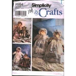 May include: A Simplicity 9604 sewing pattern envelope for dolls with bonnets and dresses. The cover features images of finished dolls, including two wearing white dresses with the embroidered text Good Night and Good Morning.