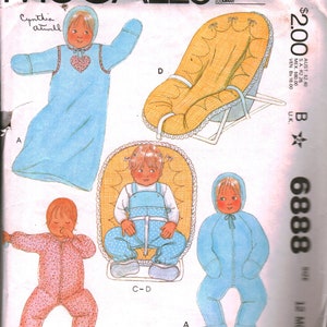 May include: A sewing pattern for baby clothes, including a hooded sleeper, a jumpsuit, and a one-piece outfit. The pattern is from McCall's and is for sizes 12 months. The pattern is illustrated with drawings of babies wearing the clothes.