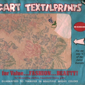 May include: A blue Vocart Text/Prints package containing hot iron transfer patterns with floral designs. The packaging features the text Vocart Text/Prints, All Colour, Washable, and You see only 1/4 of the Entire Contents, with a floral sample visible.