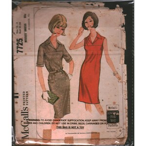 May include: Vintage McCall's sewing pattern for Misses' dresses, size 12-14. The pattern envelope features illustrations of two women wearing dresses. One dress is a muted gray, the other is a vibrant red. The envelope has text that reads "Printed Pattern".