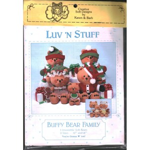 May include: A sewing pattern packet titled Luv 'N Stuff Buffy Bear Family by Creative Soft Designs by Karen & Barb. The cover features five brown plush bears in holiday outfits, including hats and scarves, with text indicating 10 and 18 inch sizes.