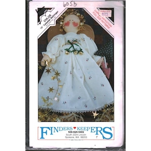 May include: A sewing pattern for a 15-inch Celestial Bellringer angel doll. The doll is wearing a white dress with star and floral accents, gold trim, and a halo. The pattern includes full-size instructions. The package is labeled "Chloe".