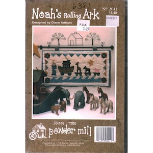 May include: A craft pattern titled "Noah's Rolling Ark" by Diane Arthurs. The cover features a quilted banner with an ark, animals, and the text "Noah's Rolling Ark." Below are wooden animal figurines, including elephants, giraffes, and zebras.