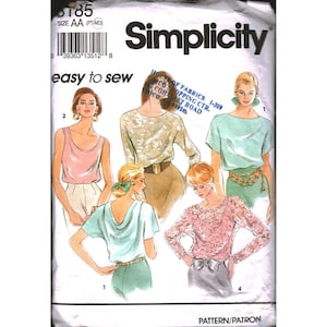 May include: A Simplicity sewing pattern envelope, number 8185, size AA. The front displays illustrations of five different tops, including a pink tank, a floral long-sleeve blouse, a green short-sleeve top, a draped back top, and a lace long-sleeve top.