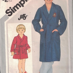 May include: Simplicity sewing pattern number 5331 for a boy's robe. The pattern includes two sizes, 10 and 12. The pattern shows a blue robe with a white collar and a red robe with a white collar.