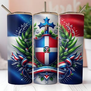 May include: A set of three stainless steel insulated tumblers with a Dominican Republic flag design. The design includes the national coat of arms, ribbons, and the words "Dios, Patria, Libertad". Each tumbler has a silver straw.