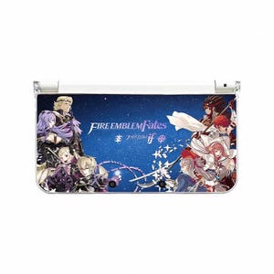 May include: A white Nintendo 3DS console featuring a blue background with characters from "Fire Emblem Fates." The console has a hinged design and a screen displaying the game's title and Japanese text.