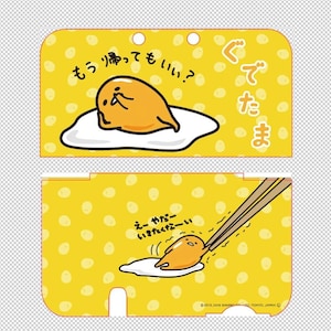 Puede incluir: Tarjeta amarilla con el personaje de dibujos animados Gudetama, un huevo. La tarjeta tiene texto japonés y un patrón de puntos. El huevo está siendo recogido por palillos.