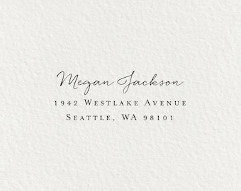 May include: A white envelope with a black return address label. The label reads "Megan Jackson, 1942 Westlake Avenue, Seattle, WA 98101."