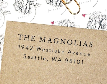 May include: A brown paper envelope with a white label that reads "THE MAGNOLIAS", "1942 Westlake Avenue", and "Seattle, WA 98101".
