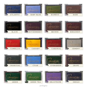 May include: A set of 20 ink pads in various colors, each with the brand name "VersaColor" and the color name printed below. The ink pads are arranged in a grid of four rows and five columns.