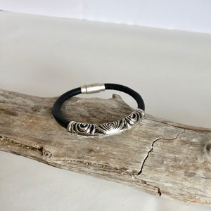Leather cuff bracelet, made of fine soft black Italian leather, accented with a gorgeous silver swirl slider, and a fine magnetic clasp.
