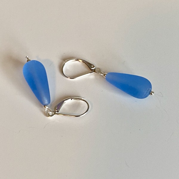 Soft sea glass type frosted sapphire blue teardrop earrings. Fashioned with a quality sterling silver lever back clasp.