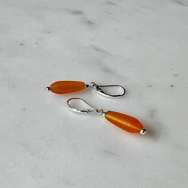 Soft sea glass type frosted amber teardrop earrings. Fashioned with a quality sterling silver lever back clasp.