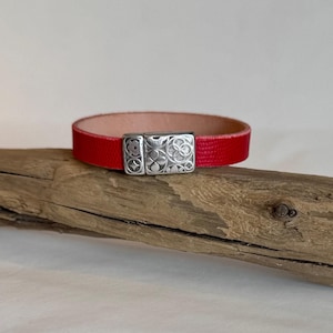 Gorgeous pebbled red Italian leather cuff bracelet. Finished with a silver le fleur magnetic clasp. Length 6.25&quot;.