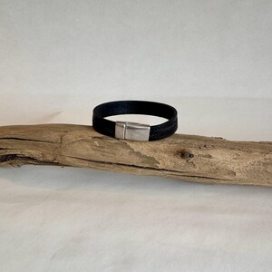 Leather cuff bracelet, made of tooled black Italian leather, and finished with a quality silver magnetic clasp. Measures 6.5&quot;.