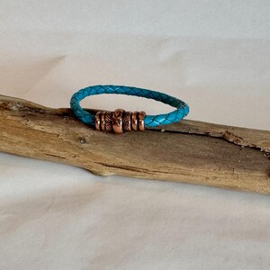 Wunderschönes geflochtenes blaues Leder in einem einzigen Wickelarmband. Gefertigt mit einem verzierten Magnetverschluss aus Messing. Länge 16,5 cm.