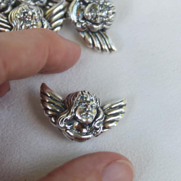 Angel sterling silver beads. Measure 1 1/4" by 3/4 ", hole goes from top to bottom for jewelry stringing