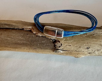 Beautiful medium blue Italian leather. Four rows finished with a quality silver magnetic clasp. Length 6.75".