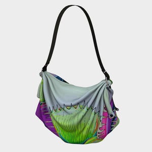 May include: A hobo-style shoulder bag featuring a vibrant, multi-colored graphic print of a Venus flytrap plant. The bag has a soft, draped fabric body with a prominent green, spiky-edged leaf design, accented by purple and pink tones, and a black strap.