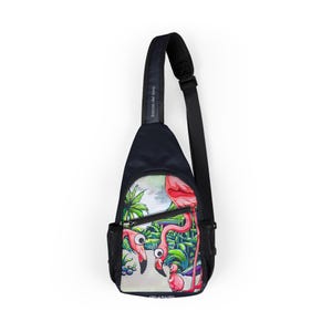 May include: A black sling bag with a colorful illustration of flamingos in a tropical setting. The bag features a black adjustable strap, a mesh side pocket, and the text "bocas de toro" on the strap.